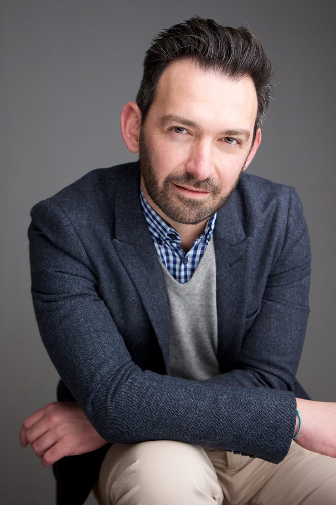 Portrait of business man against gray background